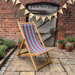 traditional deckchair sky-blue red stripes with bunting on patio