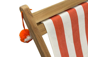 orange-pom-pom-hanging-on-jousting-deckchair.jpg