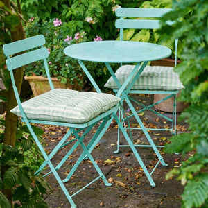 Seat pads narrow stripes on outdoor table and chairs in a garden setting