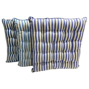 Three blue and white striped seat cushions on a white background