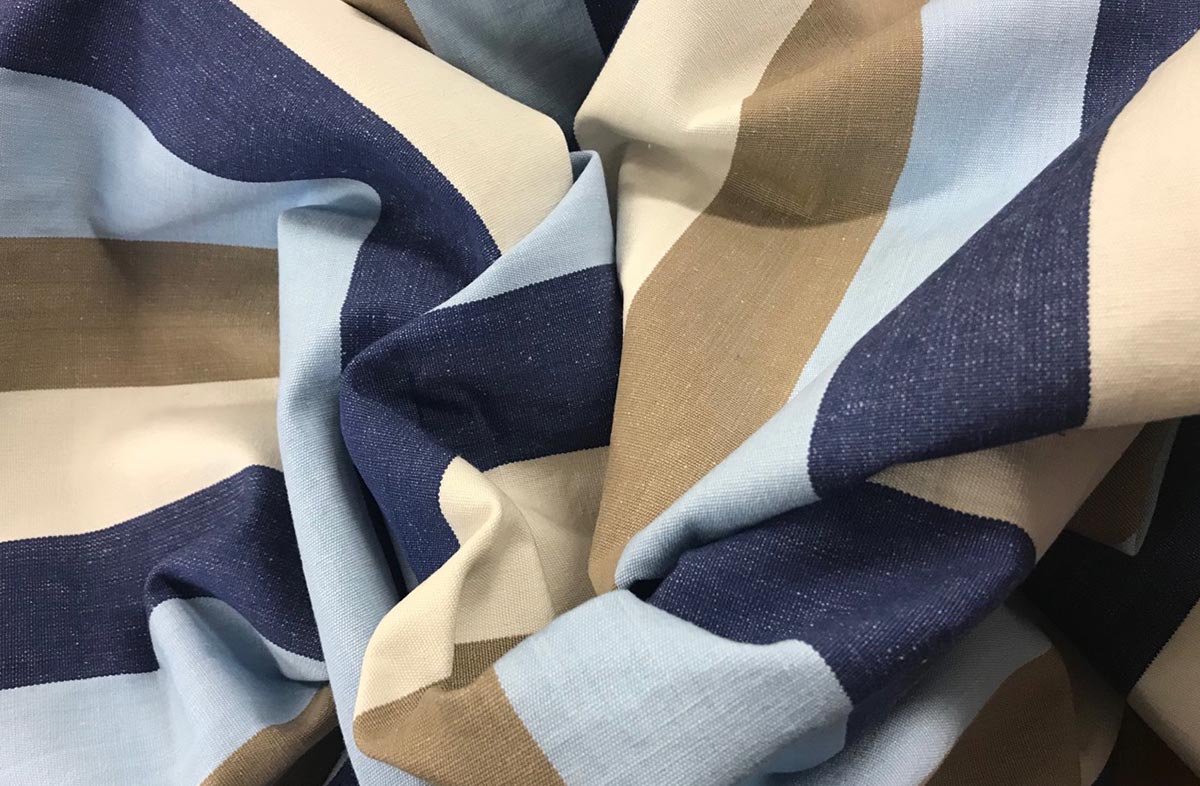 Light blue, dark blue, beige and white striped fabric