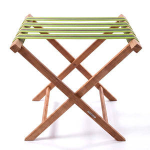 Folding wooden teak luggage rack with lime green, grey and rust red stripe cotton webbing straps for hotel guest room
