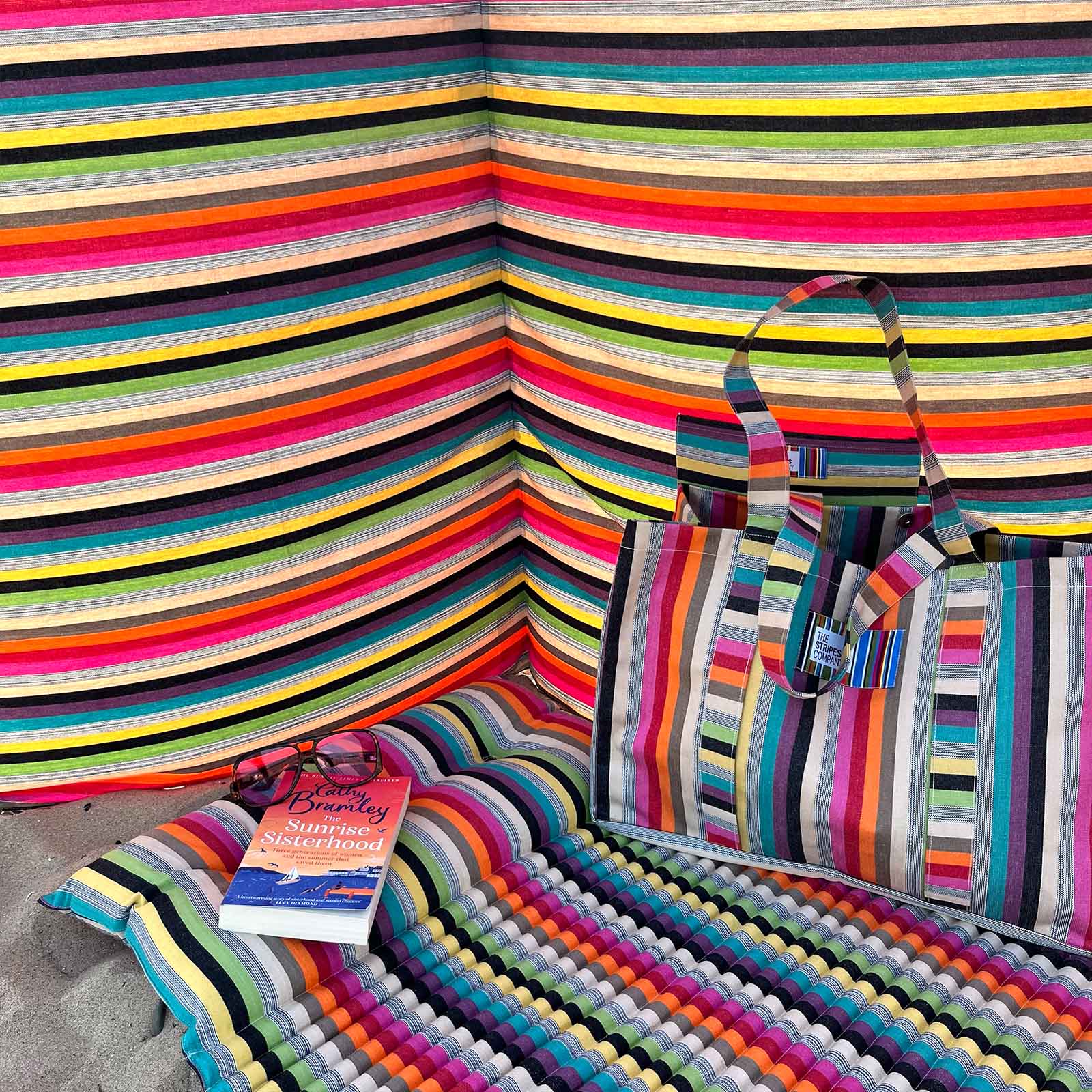 Colourful striped beach bag and beach mat with multicoloured striped windbreaker