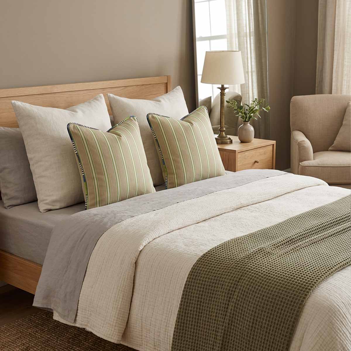 ticking piped cushions in bedroom