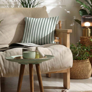 a celadon mint and white vertical striped cotton cushion on a cream sofa
