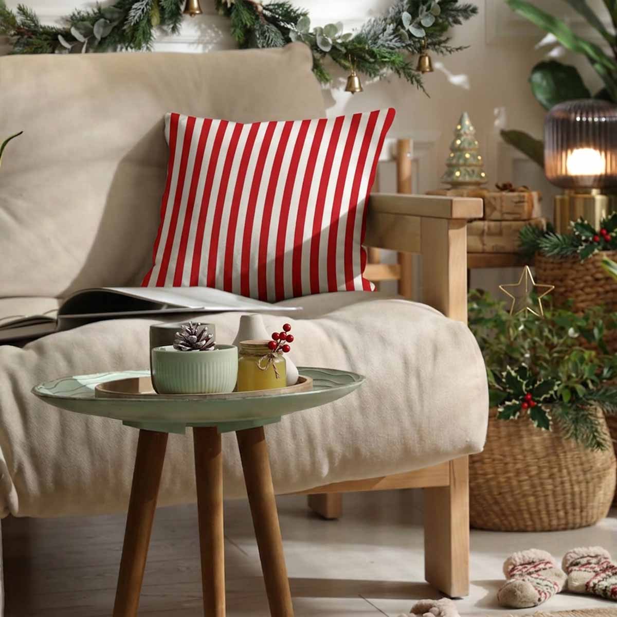 A red and white vertically striped cotton scatter cushion on a beige fabric sofa 