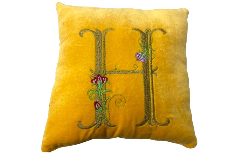 embroidery initial on velvet cushion