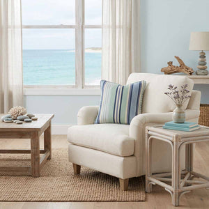 coastal living room styled with a blue and green striped cushion piped in celadon green and white stripes