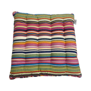 Multicolored striped cushion on a white background