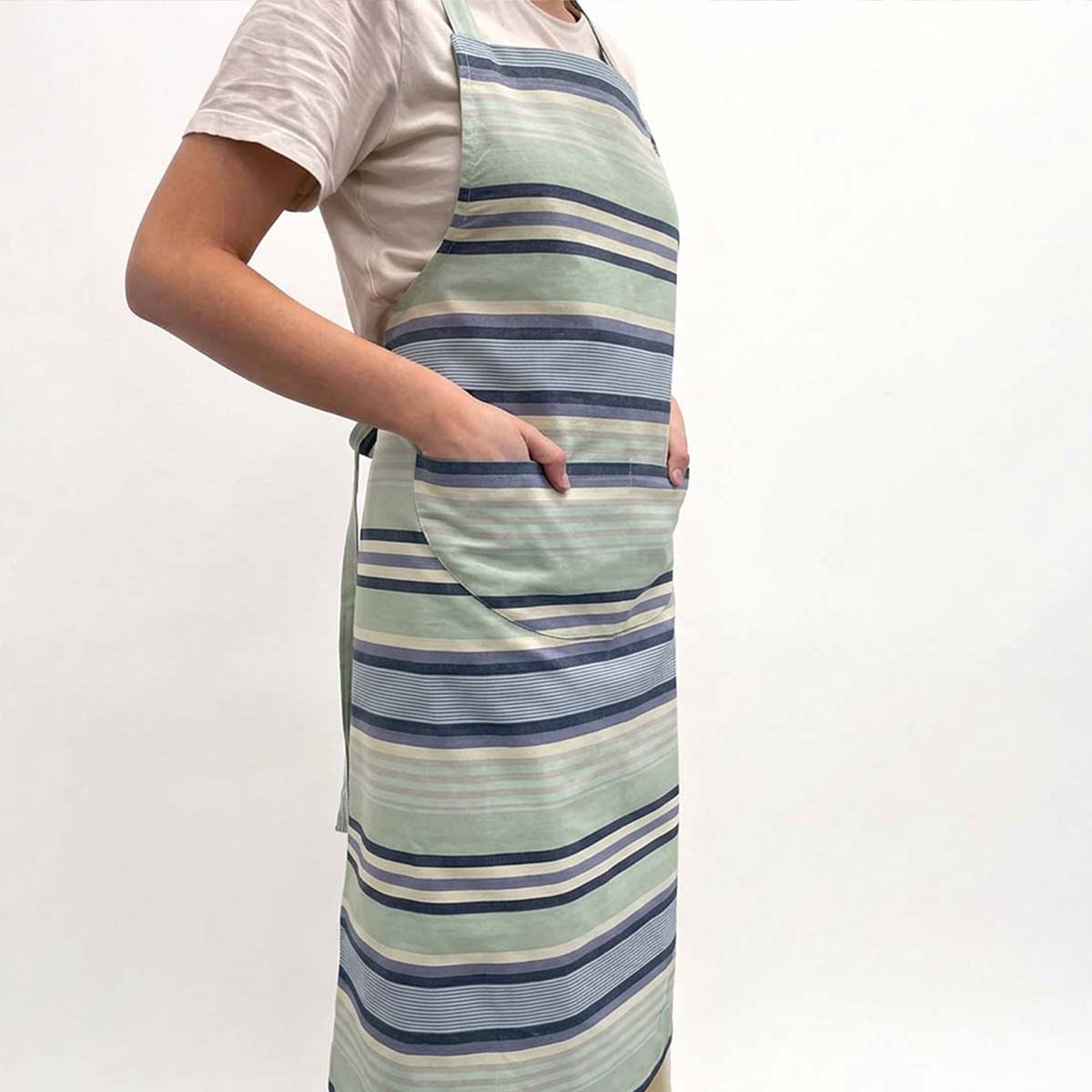 long striped apron with horizontal stripes in celadon green, navy blue, and cream