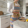 colourful striped apron with pockets in soft blues, pinks, lime green stripes