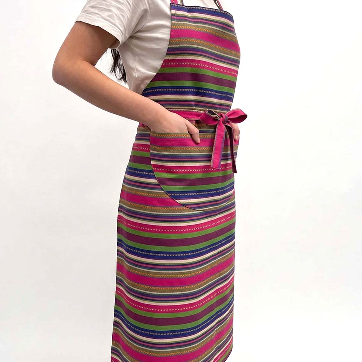 A person wearing a colourful striped apron with hot pink, green, blue, purple, beige and white horizontal stripes