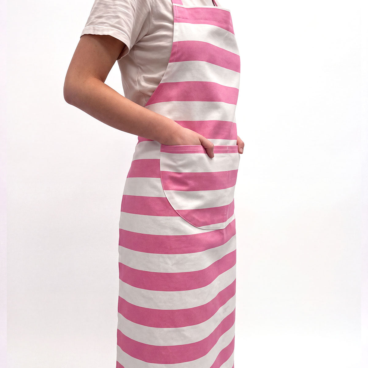 pink and white horizontally striped apron with a large front pocket