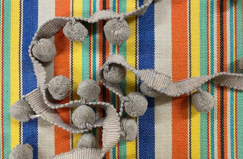 taupe-bobble-fringe-taupe-pompoms-on-solitaire-stripe-fabric.jpg